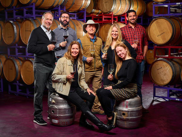A photograph of Darcie Kent, her husband David Kent, and her two daughters Kailyn and Amanda,, along with Chief Operations Officer Andrew Lauer, Winemaker Julian Halasz, and Assistant Winemaker Jerrod Martinez.